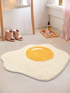 an egg shaped rug in the middle of a bedroom with shoes on the floor next to it