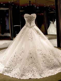 a white wedding dress on display in a store window