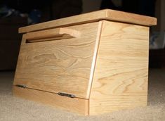 a wooden box sitting on top of a carpeted floor