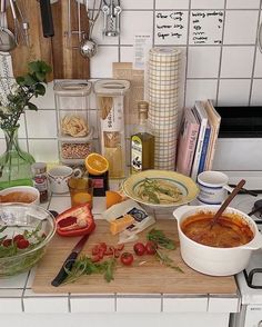 the kitchen counter is cluttered with food and cooking utensils, including pasta