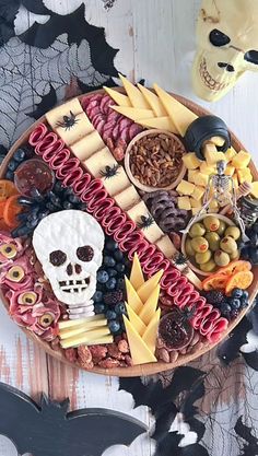 a halloween platter with cheeses, crackers, fruit and other food items