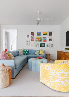 a living room filled with furniture and pictures on the wall