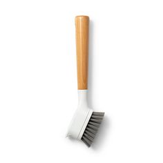 a white and grey brush with wooden handle on a white background for use in the bathroom