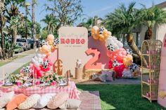 a table set up with balloons and decorations