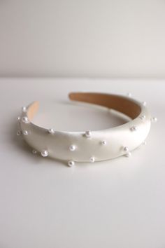 Bride padded pearl headband. This bridal white pearl headband is perfect for feminine, romantic, dreamy wedding. It's also a perfect choice for modern everlasting bridal look I hand stitch each of the pearls, so it's more durable and won't come out easily DETAILS of this bride white pearl headband: Width of this this headband: 2,5cm / 1 inches Adjustable for any of adult's head size, just like normal headband This bride white pearl headband is easy to wear - This bride white pearl padded headband is designed and handmade in Indonesia - This bride white pearl headband is available in white - Handcrafted  - White padded satin headband - This bride white pearl satin padded headband comes in a box  All of our bridal hair accessories are made to order, please see individual item for processing White Pearl Headband, Pearl Wedding Headband, Headband Bride, Pearl Headband Wedding, Headband White, Pearl Headpiece, Pearl Bride, Satin Headband, Feminine Romantic