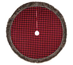 a red and black plaid round dog bed with grey fur trim on the bottom, in front of a white background