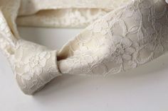 Champagne Ivory Lace Neckties are the most romantic and intricate styles I've had the pleasure of creating. They are romantic, stylish and one of a kind.This particular neck tie was hand stitched using an elegant floral champagne ivory lace underlined with a solid Ivory to give it its structure.   The lace has a light slight sheen to it, it's really just so dreamy for any special occasion.  Look at some of these other romantic styles: https://www.etsy.com/shop/HandsomeAndLace?section_id=11246759 Elegant Fitted Lace For Formal Occasions, Classic Beige Tie For Weddings, Feminine Cream Lace For Wedding, Elegant White Tie For Groom, Elegant Lace With Lace Trim For Ceremony, Cream Standard Tie For Wedding, Elegant Bow Ties For Wedding, Elegant Bow Tie For Wedding, Elegant Cream Standard Tie