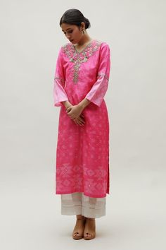 Pink silk kurta with all over bandhani pattern, floral pattern zardozi, resham embroidered yoke and sleeve panels.
Components: 1
Pattern: Embroidered
Type Of Work: Bandhani Pattern, Zardozi and Resham Work
Neckline: V Neck
Sleeve Type: Bell Sleeves
Fabric: Silk
Color: Pink
Other Details: 
Length: 48 inches
Side slits
Note: The pant worn by the model is not for sale
Occasion: Puja,Mehendi and Haldi - Aza Fashions Semi-stitched Bandhani Print Salwar Kameez, Traditional Chanderi Palazzo Set With Bandhani Print, Unstitched Chanderi Sharara With Bandhani Print, Bandhani Print Chanderi Sharara For Diwali, Festive Designer Bandhani Salwar Kameez, Designer Bandhani Print Art Silk Anarkali Set, Semi-stitched Chanderi Sharara With Bandhani Print, Designer Chanderi Sharara With Bandhani Print, Designer Chanderi Salwar Kameez With Bandhani Print