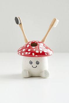 a small mushroom with two wooden sticks sticking out of it's head and eyes