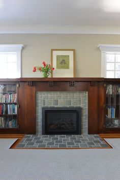 a living room with a fire place and bookshelves