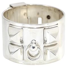 Metalheads should adore this 40-millimeter-wide, 252 gram high-polished, all sterling silver Hermès Collier de Chien Bracelet! This statement piece is heavy as it should be for fine metal and features a door knocker and four Médor studs on the top, while the bottom has more Médor studs, a turnlock, and an adjustable slide-lock closure. The piece is in prisitne condition. There’s not a bit of leather on this CDC elevating it from gladiator style to Roman goddess chic! The piece is hommage to the Hermes brand and the Collier de Chien collection. The piece is solid sterling silver and was made in France. The bangle measures 7 inches all the way around. The piece is being sold as is, and is priced to sell fast! Long Necklace Outfit, Roman Goddess, Slide Lock, Door Knocker, Door Knockers, Bracelet Silver, Long Necklace, Metallica, Cuff Bracelets