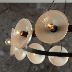 a chandelier with five lights hanging from it's sides and four bulbs on each end