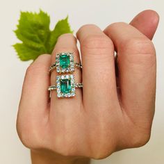 This fantastic Emerald & Apatite ring is the perfect reflection of spring. The color of this central Emerald is gorgeous with exceptional luster. Surrounded by a stunning bright blue Apatite border, the unexpected combination is exciting.  Emeralds have been made into jewelry for centuries. It symbolizes renewal an Emerald Cut Gemstones With Halo Setting, Radiant Cut Gemstone Halo Ring, Emerald Gemstones With Halo Setting Fine Jewelry, Blue Emerald Ring With Halo Setting, Blue Emerald Rings With Halo Setting, Blue Emerald Halo Setting Ring, Emerald Cut Halo Ring With Accent Stones, Fine Jewelry Turquoise Sapphire Ring With Accent Stones, Turquoise Sapphire Ring With Accent Stones