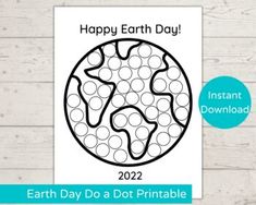 the earth day dot printable is shown on a wooden background