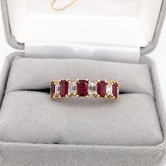 This beautiful band ring features five emerald-cut ruby gemstones of 1.56-carat weight with six natural earth-mined diamonds, all set in solid 14K gold. This band ring is made with solid 14K Gold and natural Earth mined SI / G-H diamonds. Emerald Cut Ruby Ring With Multi-stone, Emerald Cut Ruby Ring With Vvs Clarity, Emerald Cut Multi-stone Ruby Ring, Ruby Band Ring, Designer Silver Jewellery, Ruby Bands, Jewelry Showcases, Ruby Gemstone, Red Ruby