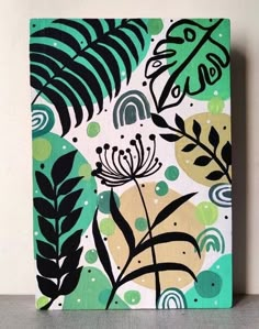 a painting with green leaves and circles on the bottom, against a white wall background