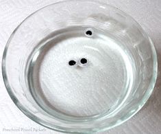 two black eyes in a clear glass bowl on a white tablecloth with polka dots