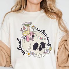 Express your unique style with our Dead Inside But Still Groovy shirt. Featuring a quirky mushroom skull design, this shirt is perfect for those who embrace their dark humor while staying effortlessly cool. Ideal for casual wear or as a gift for friends who appreciate a blend of edginess and grooviness. Fun Skull Print Crew Neck T-shirt, Casual Long Sleeve Top With Mushroom Design, Casual Skull Custom Print T-shirt, Fun Cotton Tops With Skull Print, Relaxed Fit Tops With Mushroom Print For Streetwear, Mushroom Print Cotton Top For Streetwear, Relaxed Fit Mushroom Print Top For Streetwear, Cotton Mushroom Print Top For Streetwear, Cotton Top With Mushroom Print For Streetwear