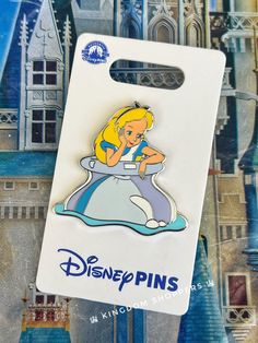 a pin with a cartoon character on it sitting in front of a disney world sign