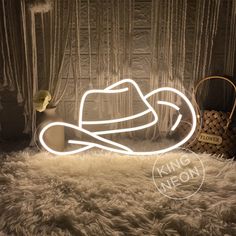 a white hat sitting on top of a furry rug