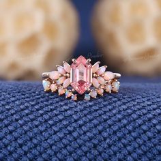 an image of a ring with pink stones on it