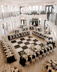 a large room with tables and chairs set up for a formal function in the center