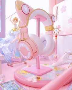 there is a pink toy with headphones on top of the stand in the room