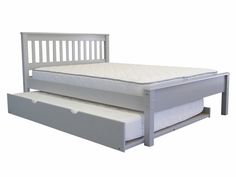 a white bed with two drawers underneath it