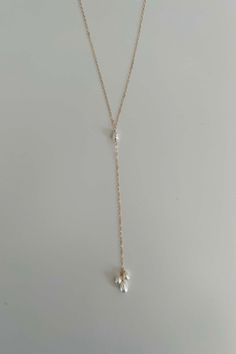 Completely handcrafted in our New York studio, the Petals Back Drop Necklace features a diamond cut dainty chain and 6-8 mm freshwater pearl dangles. Lightweight and easy to wear. Wear this two ways - can be worn in the back or in the front. Clasp: none Materials: 100% 14k Gold Filled or Sterling Silver Measures approx. 26" in length + 4" drop Handmade in New York Arrives in a keepsake clutch and box Bow and earrings sold separately Sterling Silver Lariat Pearl Necklace, Sterling Silver Lariat Necklace With Pearl Drop, Sterling Silver Lariat Pearl Chain Jewelry, Sterling Silver Pearl Drop Lariat Necklace, Sterling Silver Lariat Pearl Necklace With Pendant, Adjustable Pearl Drop Necklace, Adjustable Pearl Pendant Drop Necklace, Elegant Teardrop Dangling Beads Necklaces, Dainty Pearl Charm Lariat Necklace