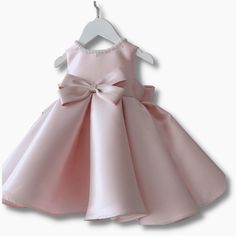 A beautiful dress for a little princess. The soft and delicate yoke features pearl embroidery collar, bow at the front and back with a zip at the back for easy change. This pink bow dress for baby girls is the perfect outfit for her special occasion. Material: Cotton Polyester Spring Pageant Princess Dress With Bow, Princess Baptism Dress With Bow, Princess Style Baptism Dress With Bow For Formal Occasions, Spring Baptism Princess Dress With Bow, Spring Princess Dress With Bow For Baptism, Spring Princess Dress With Pink Bow, Pink Bow Dress For Dress-up, Spring Pageant Dress With Bow, Elegant Dress With Pink Bow For Dress-up