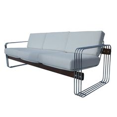 a white couch sitting on top of a metal frame