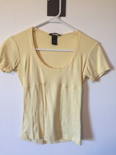 Pale Yellow Short Sleeve Round Neck Women's Top Brand: Moda International Size: small Material: 100% cotton  Soft and comfy shirt  length is just at waist or slightly cropped Hanger not included. Previously Worn. We recommend all clothing purchased be cleaned before wear.  These are vintage finds discovered and sold as is. ALL SALES FINAL!!  NO RETURNS!! Affordable Vintage Yellow Shirt, Fitted Cotton Crop Top For Loungewear, Spring Cotton Crew Neck Crop Top, Casual Cropped Cotton Top, Spring Cotton Crop Top T-shirt, Spring Cotton T-shirt With Stretch, Stretch Cotton T-shirt For Spring, Fitted Scoop Neck Cotton Top, Everyday Cotton Scoop Neck Crop Top