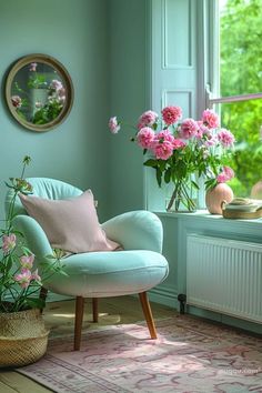 a room with pink flowers in vases on the windowsill and a blue chair