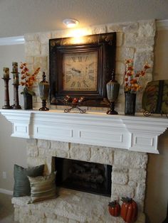 a fireplace with a clock on the mantle