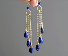 "These stunning earrings are inspired by nature, they have a pure simplicity as the three micro-faceted lapis lazuli drops hang in a cascade from their 14 karat gold filled chains. These earrings are made using the finest AAA+ quality Afghan lapis lazuli and are guaranteed to impress with their classic elegance. Due to their original design they shimmer with movement creating a fantastic cascade of gorgeous blue shimmering light. This fabulous pair are guaranteed to make you stand out from the c Blue Gemstone Earrings, Lapis Jewelry, Lapis Earrings, 9th Anniversary, Lapis Lazuli Jewelry, Lapis Lazuli Earrings, Earrings Blue, Anniversary Gift For Her, Stunning Earrings