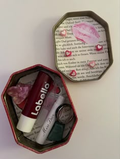 two tins with lip products in them on a table