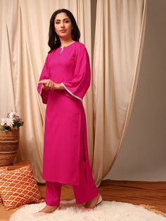 This Magenta Kurta with Trousers is designed with a solid, straight shape and regular style for a timeless look. The round neck, three-quarter flared sleeves and calf length hem add elegance, while the silk blend machine weave fabric ensures comfort. The solid trousers with partially elasticated waistband and slip-on c Spring Sets With Side Slits, Elegant Kurta With 3/4 Sleeve For Eid, Elegant 3/4 Sleeve Kurta For Eid, Elegant Summer Sets With 3/4 Sleeve, Elegant Summer Kurta With Set-in Sleeves, Elegant Festive Set With 3/4 Sleeve, Elegant Festive Sets With 3/4 Sleeve, Elegant Holiday Set With 3/4 Sleeves, Western Kurtis