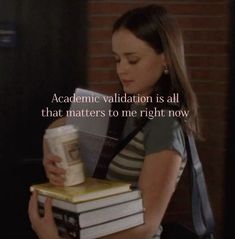 a woman holding a stack of books with the caption that reads,'academy validation is all that matters to me right now