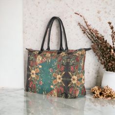 "Retro Cottagecore Teal Green floral Witch handbag, Witchy boho zip tote, Pagan Witch Occult aesthetic art bag with vegan leather handles      Oxford Fabric, 15\"(L) x 7\"(W) x11.4\"(H) x 7.6\"(Handle), Two Sides Printing     14.46 Oz. Made from durable oxford fabric.     Metal button closure.      Dimensions: 15\"(L) x 7\"(W) x 11.4\"(H) x 7.6\"(handle).     Large capacity. It contains 1 main large compartment and small zipper pocket. ❣️PRODUCTION and DELIVERY TERMS: This item will be shipped out from China The production takes 5-7  business days International delivery time is 10-20 business days. Ref:847 Sense Forest would like to provide some clarity regarding the creation of our designs. We take pride in crafting all our designs in our dedicated workshop located in Las Vegas, USA. For Floral Print Tote Satchel For Daily Use, Bohemian Tote Shoulder Bag With Floral Print, Bohemian Shoulder Bag With Floral Print Tote, Bohemian Floral Print Tote Shoulder Bag, Vintage Weekender Tote Bag, Bohemian Rectangular Satchel For On-the-go, Bohemian Bags With Floral Print For Daily Use, Bohemian Bags With Floral Print, Floral Print Top Handle Bag For Travel