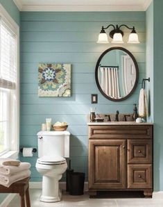 a bathroom with blue walls and white tile on the floor, along with a wooden vanity