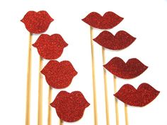 red glitter lips on wooden sticks with toothpicks in the shape of heart shapes