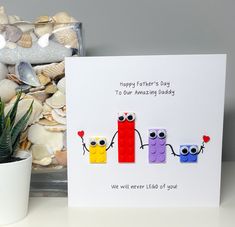 a card with two legos holding hands and the words happy father's day to our amazing daddy