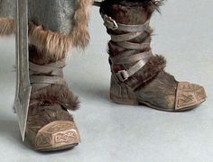 a close up of a person's boots with fur on them