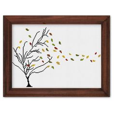 a cross stitch picture with leaves falling from a tree