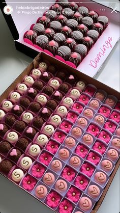 two boxes filled with pink and brown cupcakes on top of a table next to each other