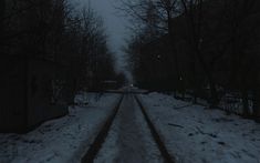 an empty road with snow on the ground