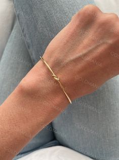 All Our Bracelets Are Made Of REAL 14K GOLD  14K yellow Gold Love Knot Cuff Bangle Bracelet, Real Gold Bangle, Stackable Bangle, Women  Shop our 14K Bracelets https://www.etsy.com/shop/GOLDMANIA?ref=seller-platform-mcnav§ion_id=26925987  Shop On Sale items https://www.etsy.com/shop/GOLDMANIA?ref=seller-platform-mcnav§ion_id=1  Metal: 14K Yellow Gold    Width: 2 MM  Length: 7 IN  Closure: Cuff Weight: 2.80 Gram   Knot dimension: 5 mm   SHIPPED FROM NEW YORK CITY FREE SHIPPING on all orders IN THE Golden Bracelet Aesthetic, Dainty Bangle Cuff Bracelet For Anniversary, Dainty Anniversary Cuff Bracelet Bangle, Gold Plated Bangle For Anniversary, Yellow Gold Jubilee Cuff Bracelet For Wedding, Adjustable Yellow Gold Wedding Bangle, Modern Gold Plated Bracelet For Weddings, Modern Yellow Gold Wedding Cuff Bracelet, 14k Gold Cuff Bracelet For Anniversary