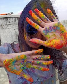 a woman with her hands covered in paint