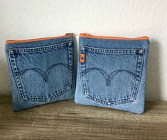 two small denim pouches with hearts on them