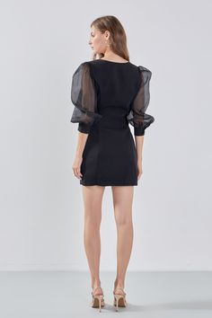 This Organza Blouson Mini Dress is the perfect addition to your wardrobe! Beautifully crafted from a mix of organza and other materials it features a boat neckline fitted bodice and mini length. Show off your legs and make a statement in this head-turning dress. It is sure to leave a lasting impression with its unique design and its exquisite materials will ensure you look stunning all night long. Make it yours today! Mixed media Mini length Boat neckline Fitted bodice Organza blouson sleeves Cu Formal Fitted Mini Dress With Sheer Bodice, Fitted Organza Mini Dress For Evening, Elegant Black Mini Dress With Sheer Bodice, Black Mini Dress With Sheer Bodice, Chic Sheer Organza Mini Dress, Organza Mini Dress With Sheer Bodice For Party, Sheer Mini Length Formal Dresses, Sheer Mini Dress For Evening, Fitted Organza Mini Dress